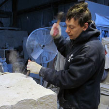 CHRIS PELLETTIERI WORKING ON A BLOCK OF LIMESTONE